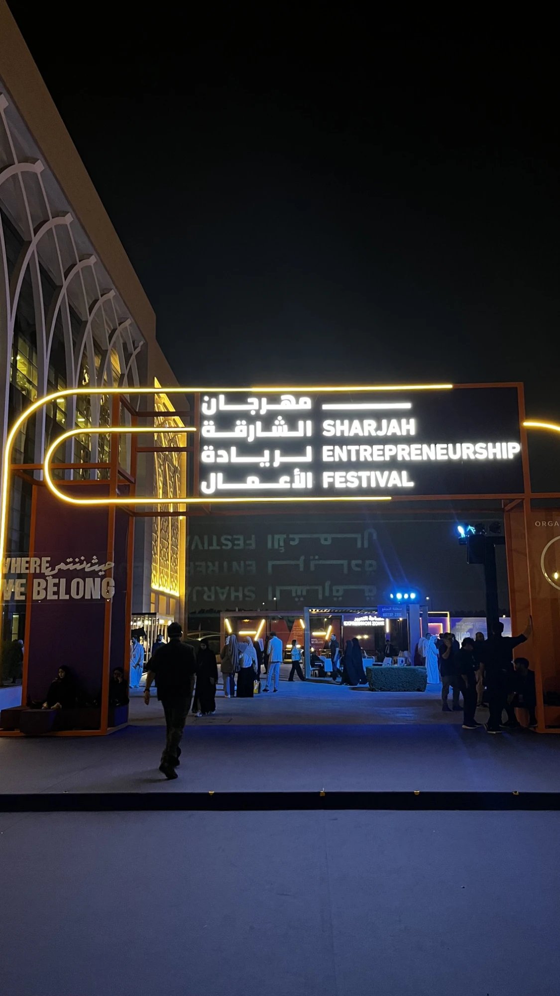 The lit entrance of the Sharjah Entrepreneurship Festival at night
